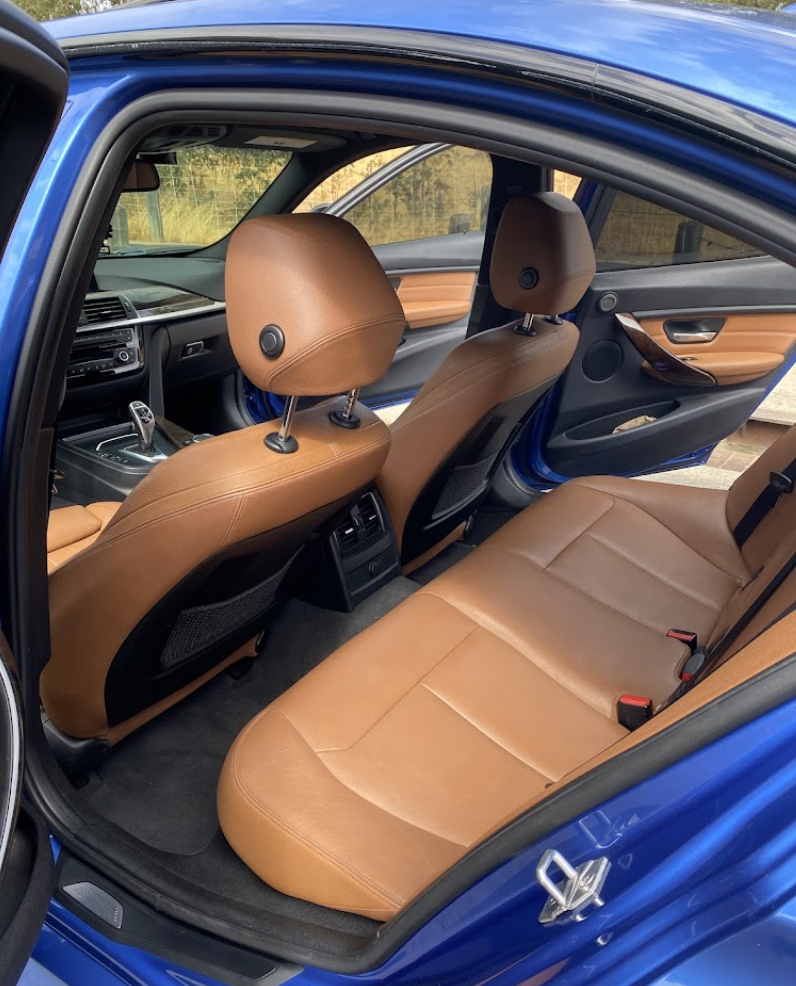 Clean tan leather BMW interior after mobile interior car detailing