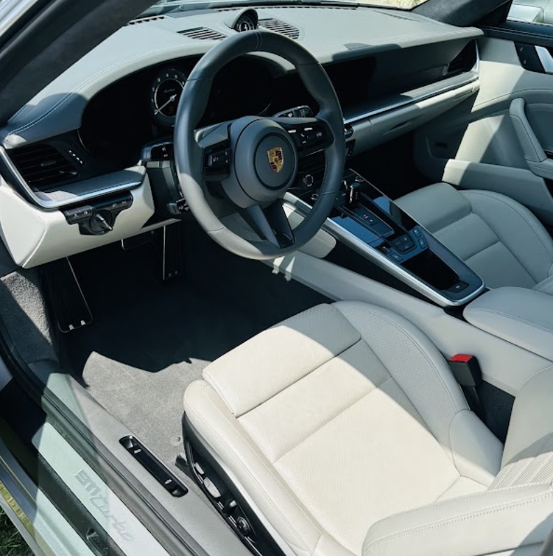 Light gray Porsche 911 interior cleaned and conditioned after leather detailing