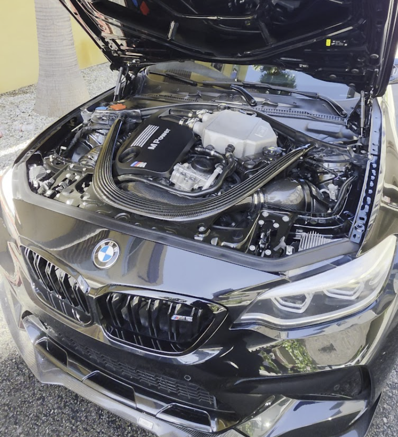Detailed BMW M engine bay and polished black exterior paint